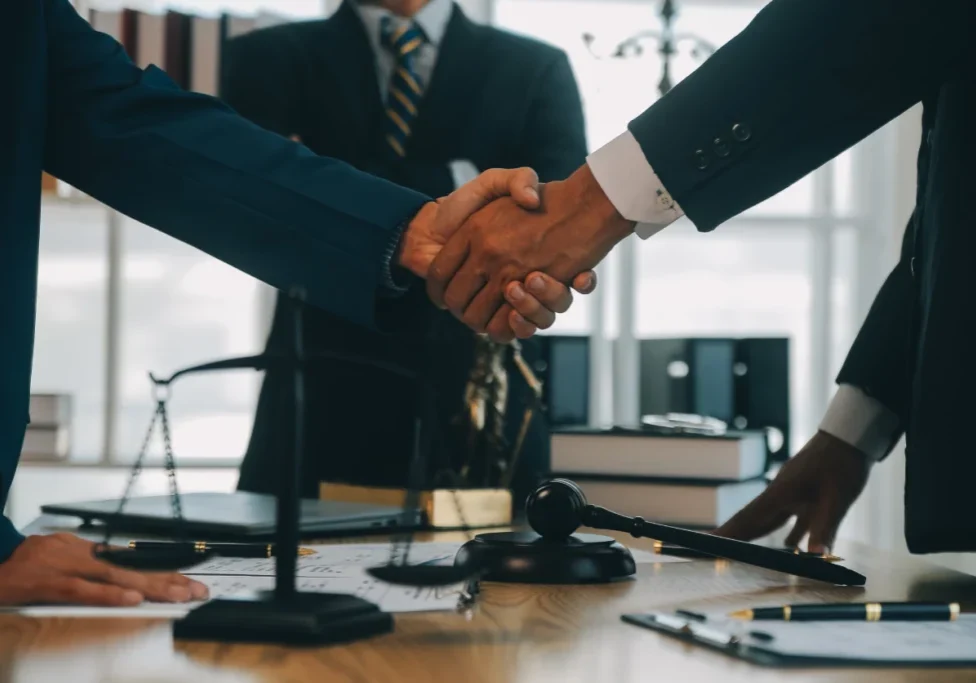 Handshake over legal documents and gavel